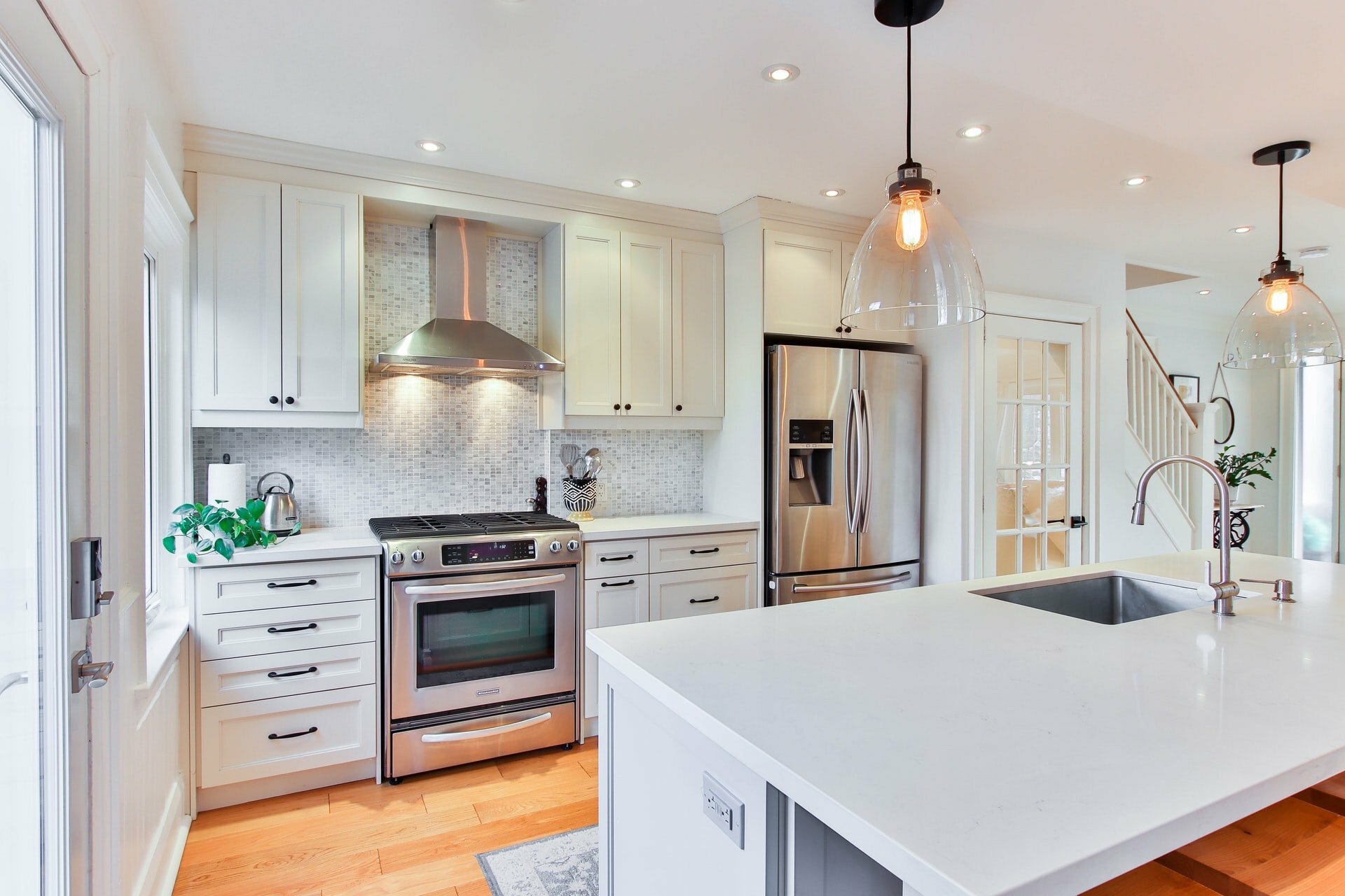 a kitchen with white cabinets